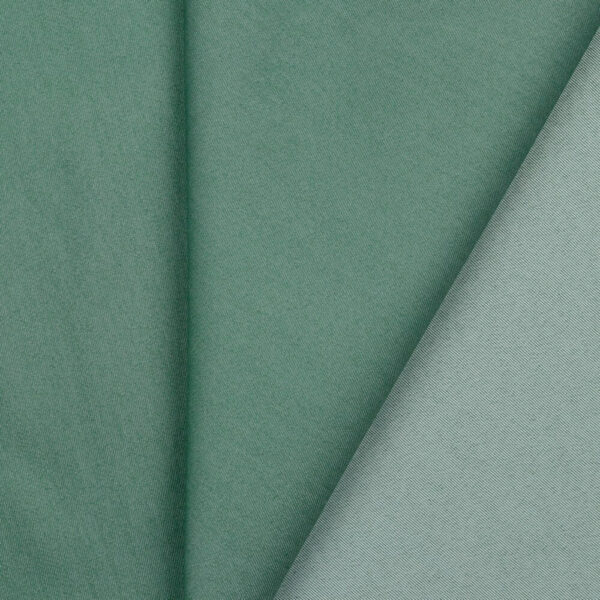 Green denim fabric folded close up