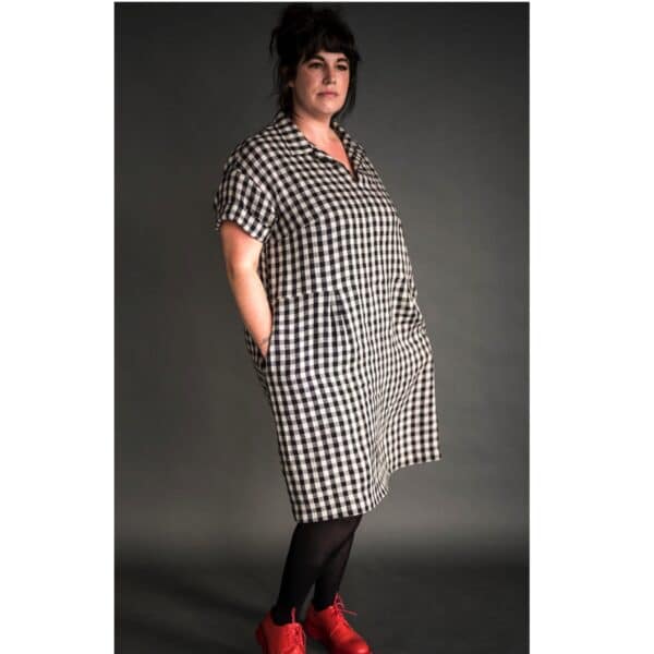 lady wearing merchant and mills dress pattern in a black and white check