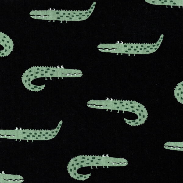 Green alligator on black fabric