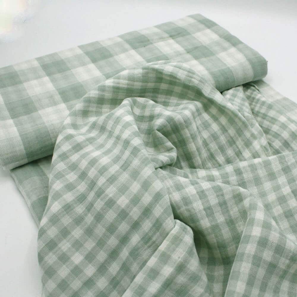bolt of gingham double gauze Fabri showing two sizes of check