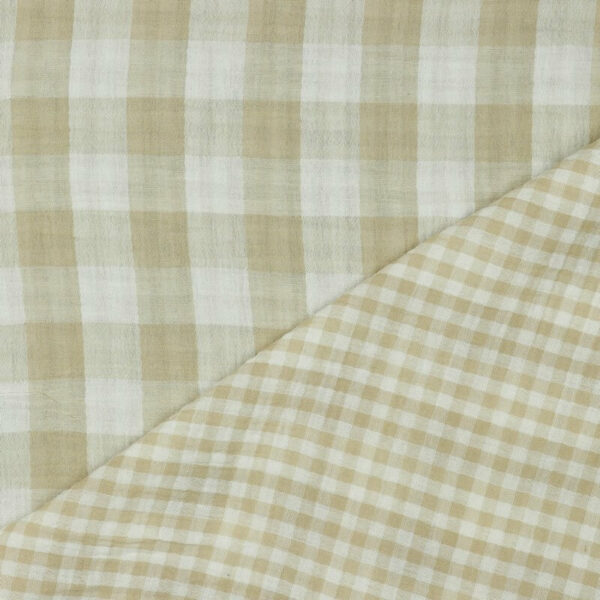close up of gingham double gauze with one corner folded to show both size of checks