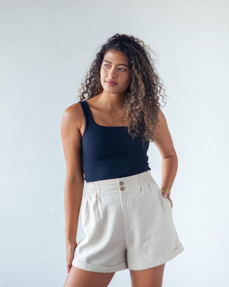 lady wearing cuffed shorts with elastic waist in white and navy top