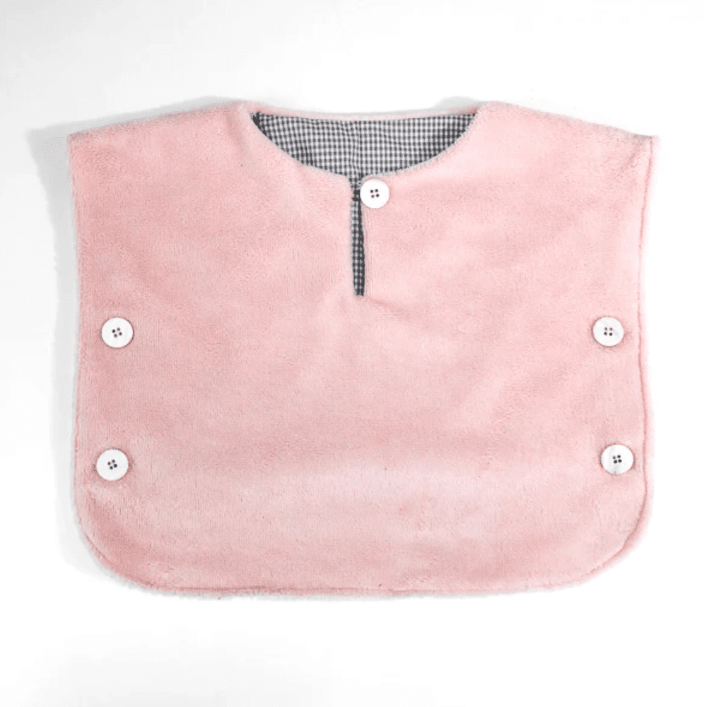 soft pink fleece poncho top laying on a white coloured ground