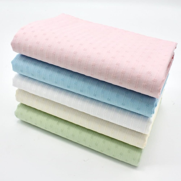 fabric pile all colours cotton lawn fabric at an angle