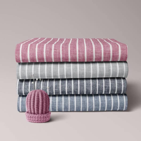 folded bundle of linen and cotton fabrics in colourful stripes