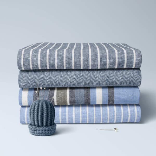 folded bundle of linen and cotton fabrics in colourful stripes