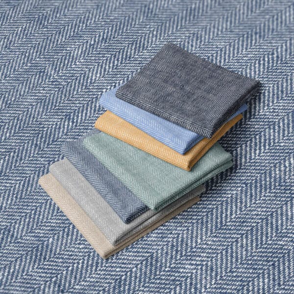 folded squares of linen and cotton stripe fabric in a row