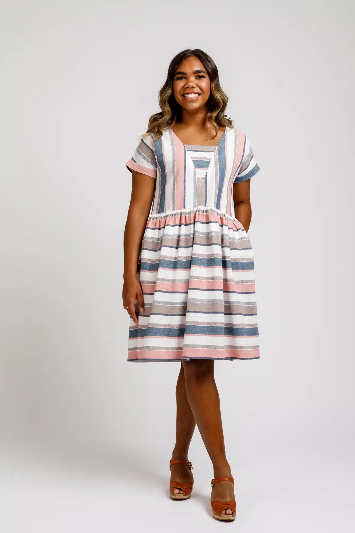 young girl modelling a knee length stripe chambray dress Olive dress pattern by Megan Nielsen
