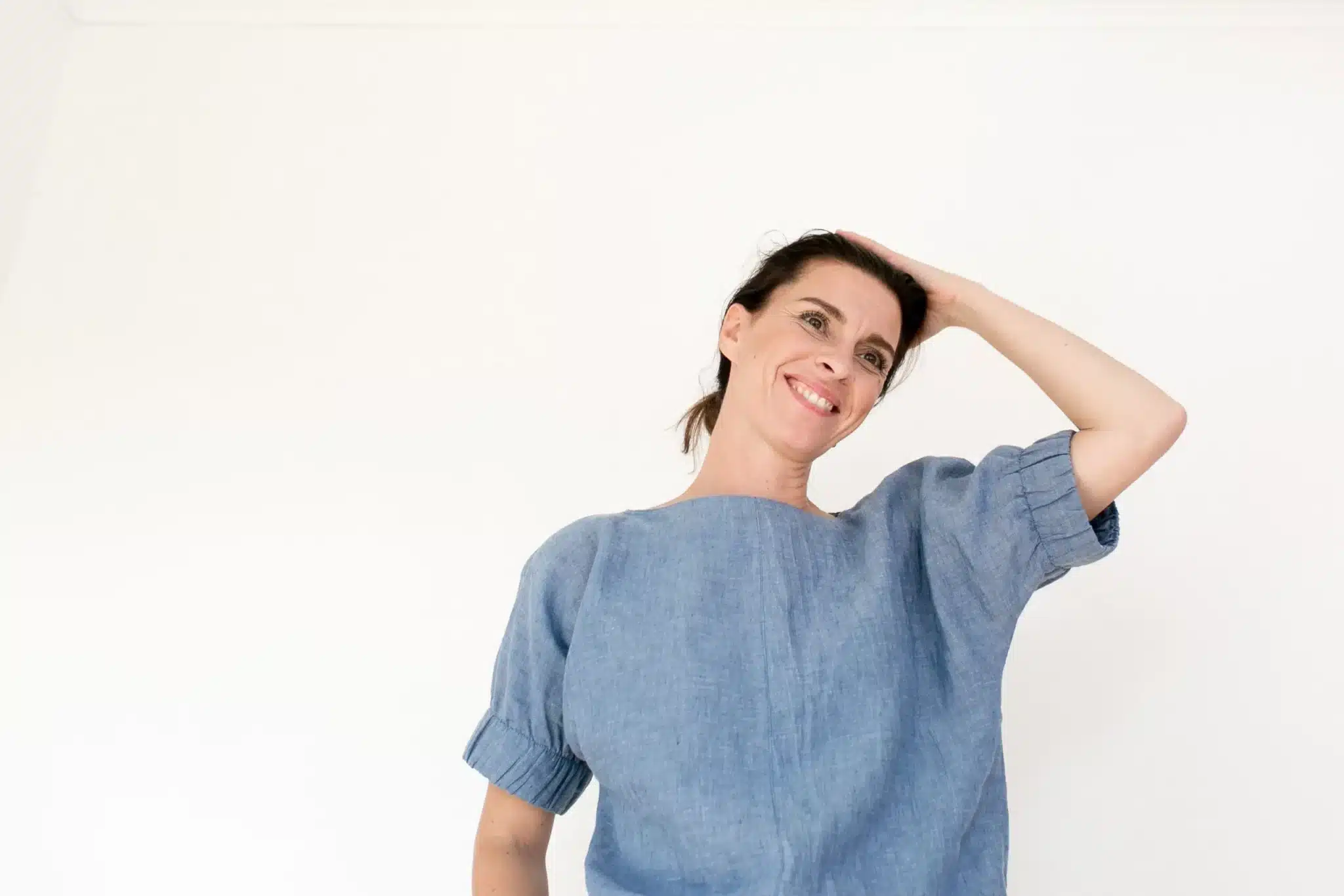 lady wearing a blue cuff blouse with sort sleeves from The Assembly Line