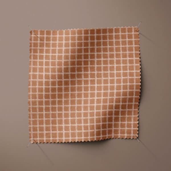 Sample swatch of camel grid print cotton fabric from the Felina collection