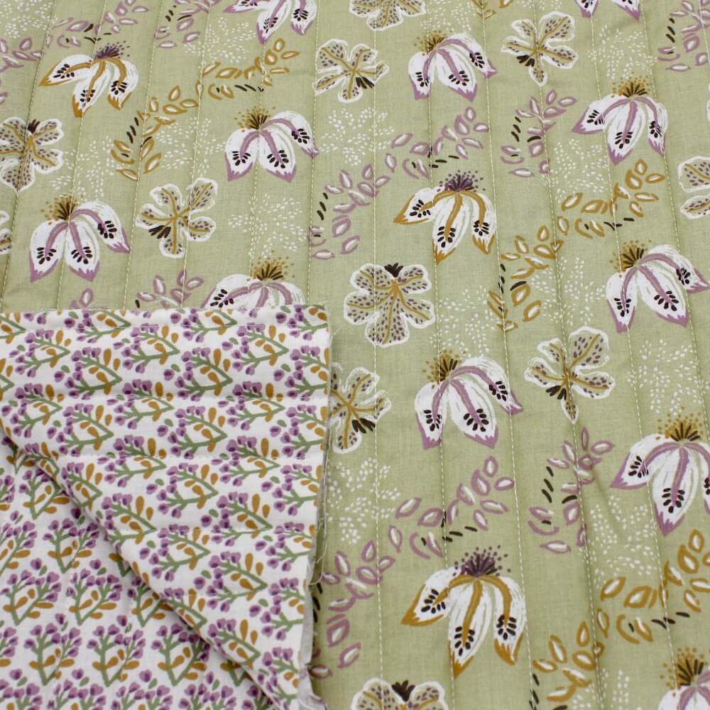 Quilted double sided cotton fabric in a pale green modern indienne floral