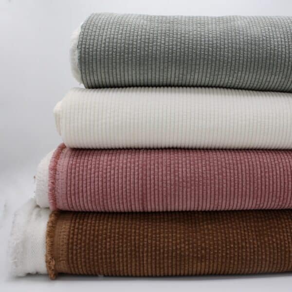.All colours in faux fur backed bubble corduroy in a pile