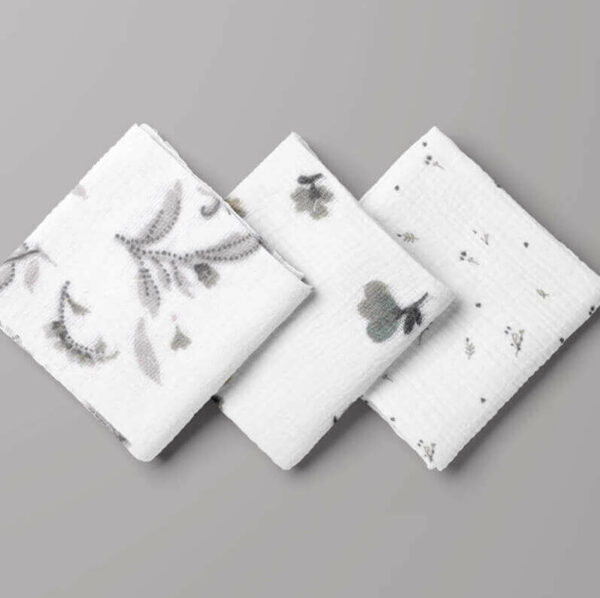 folded squres of grey floral on white double gauze