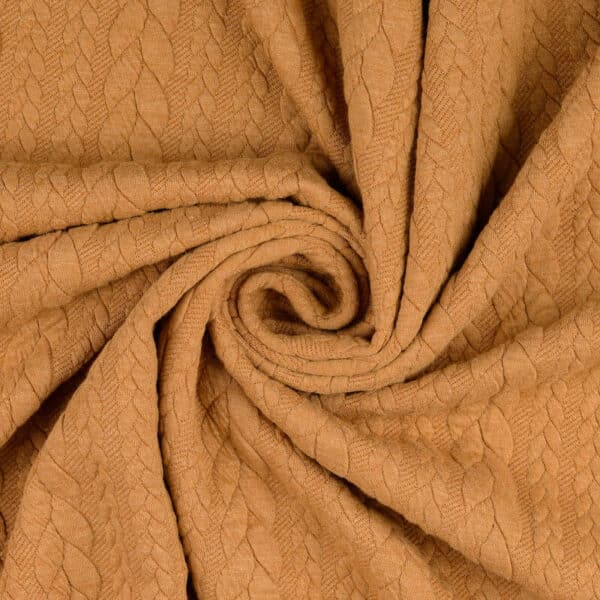 Ochre yellow cable knit jersey fabric in a swirl