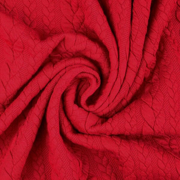 Raspberry pink cable knit jersey fabric in a swirl