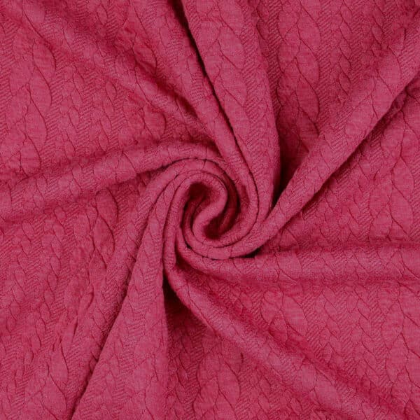 Raspberry pink cable knit jersey fabric in a swirl