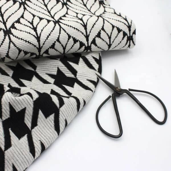 black and cream knit jersey fabric bundle with scissors