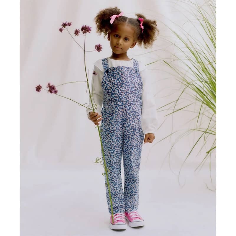 child wearing flowery liberty dungarees