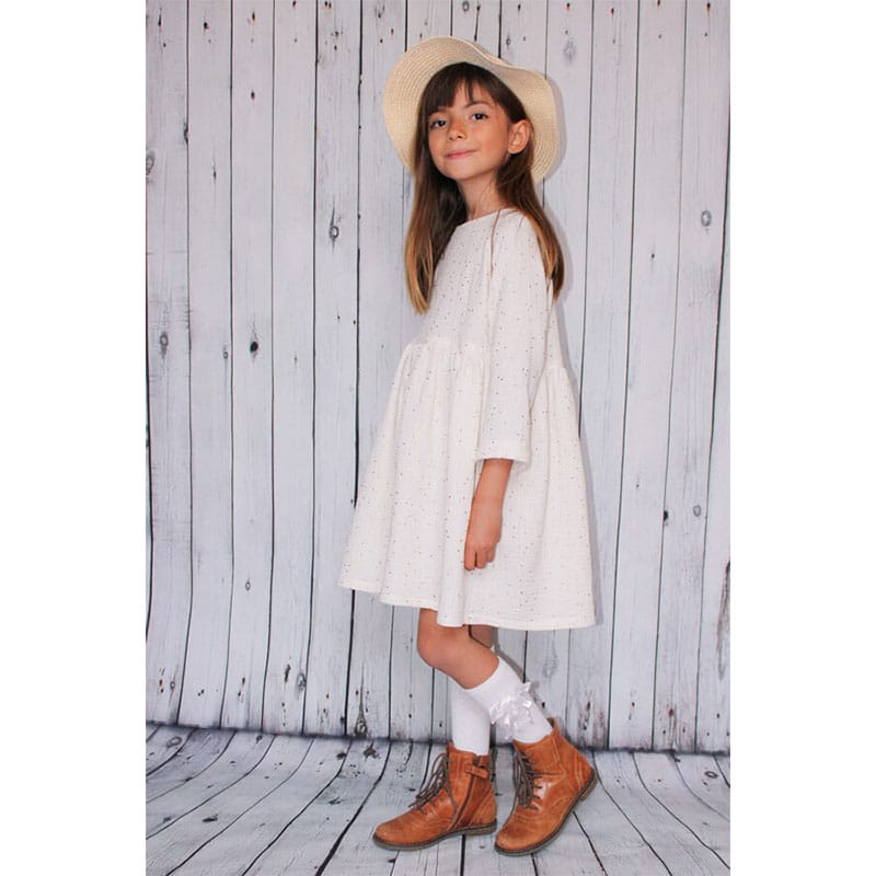 girl wearing white i am patterns dress with hat