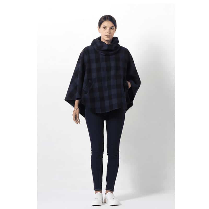 lady wearing blue and black check ponco top