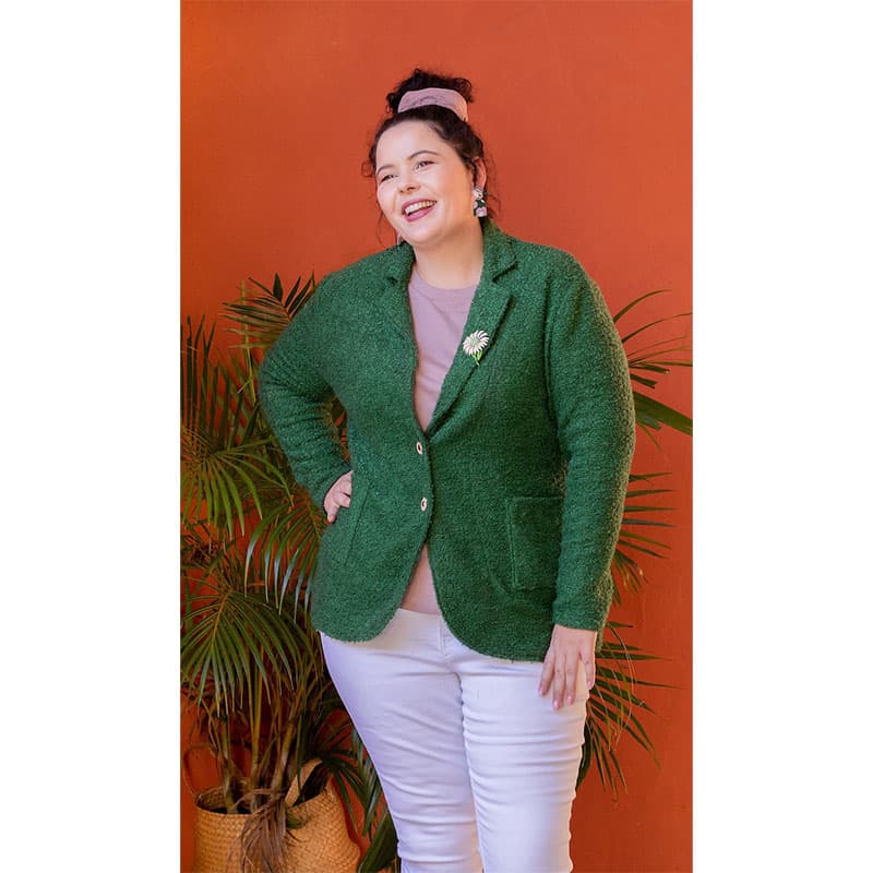 lady wearing green jacket cream trousers