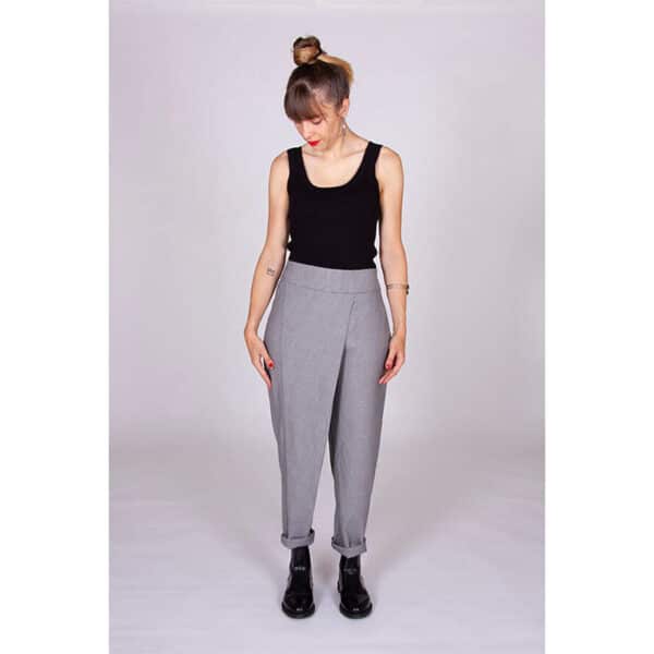 lady wearing grey i am patterns trousers and black top