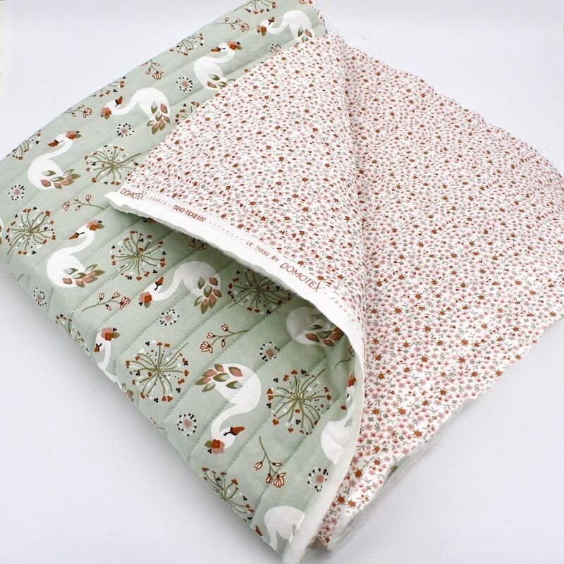 Double sided quilted cotton with fold in green and peach swans