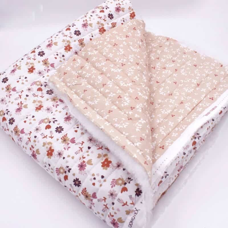 Double sided quilted cotton with fold in white and peach florals